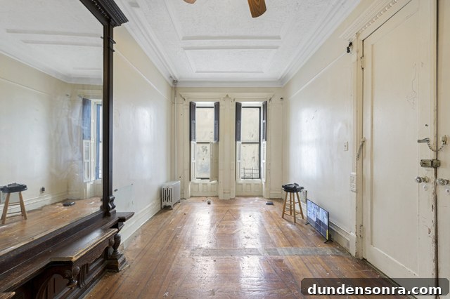 A room with a wooden floor and windows