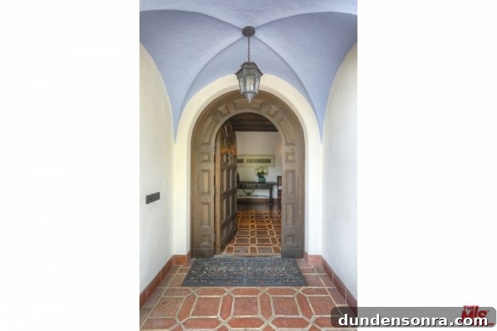 The entrance to a spanish style house with tile