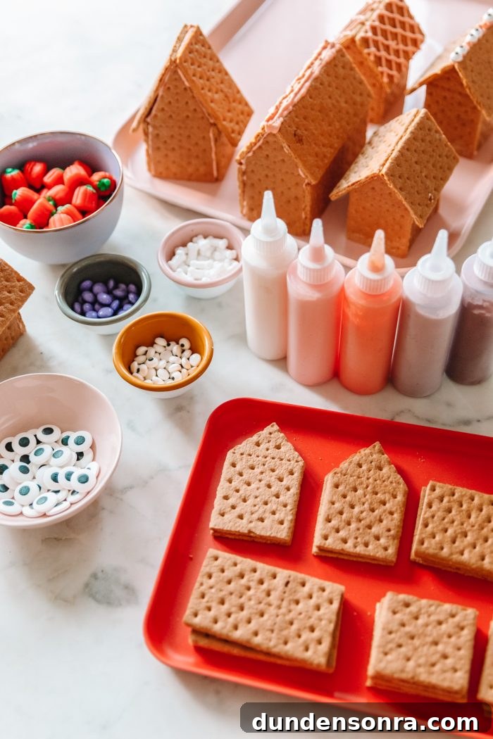 Edible Haunted Houses: Halloween Candy House Ideas and Guide 14 A tray of graham crackers with frosting and toppings on the side