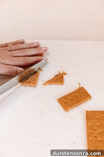 Someone cutting a graham cracker