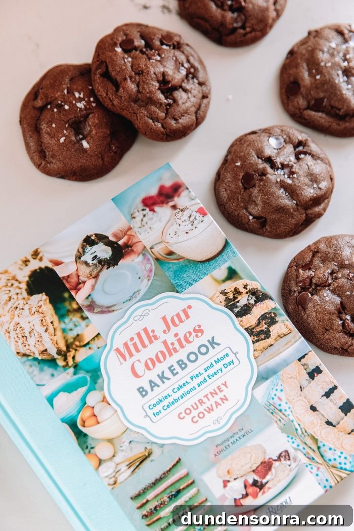 Chocolate chip cookies next to a book about cookies