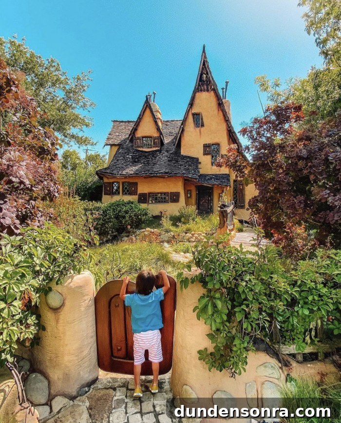 Spadena House in Beverly Hills with child looking over the gate