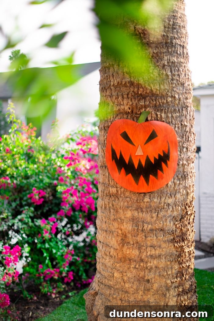 A pumpkin decoration on a palm tree