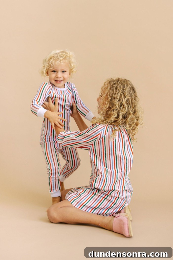 Two kids in striped holiday pajamas