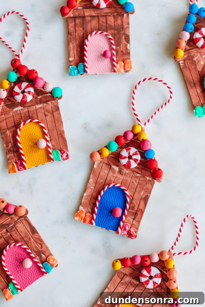 Popsicle stick gingerbread house ornaments on a table
