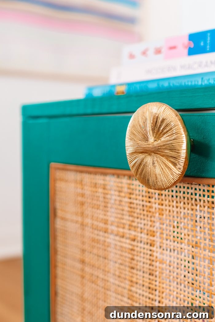 Rattan IKEA Besta TV Stand Makeover: Step-by-Step Hack 4 A close up of a turquoise cabinet with gold handle