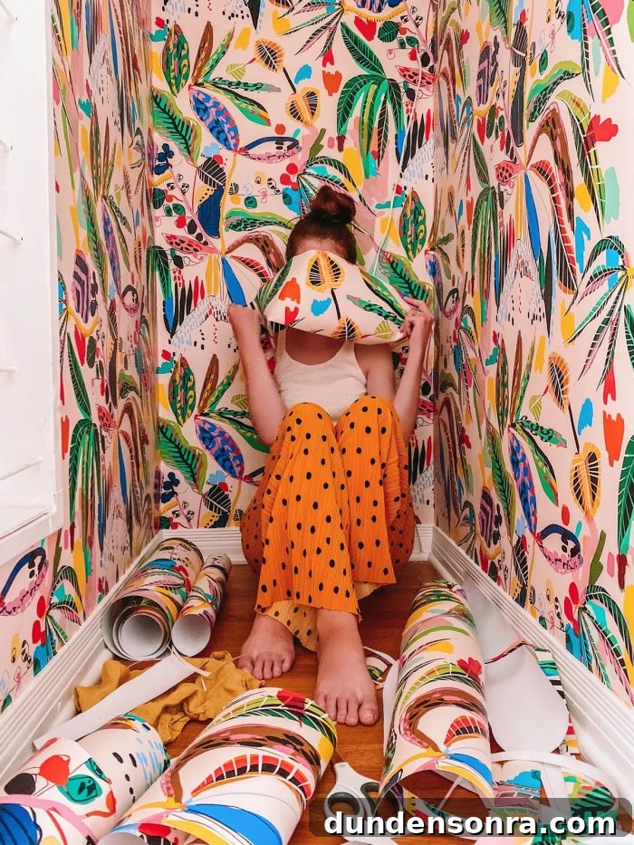 A women in a closet with colorful wallpaper