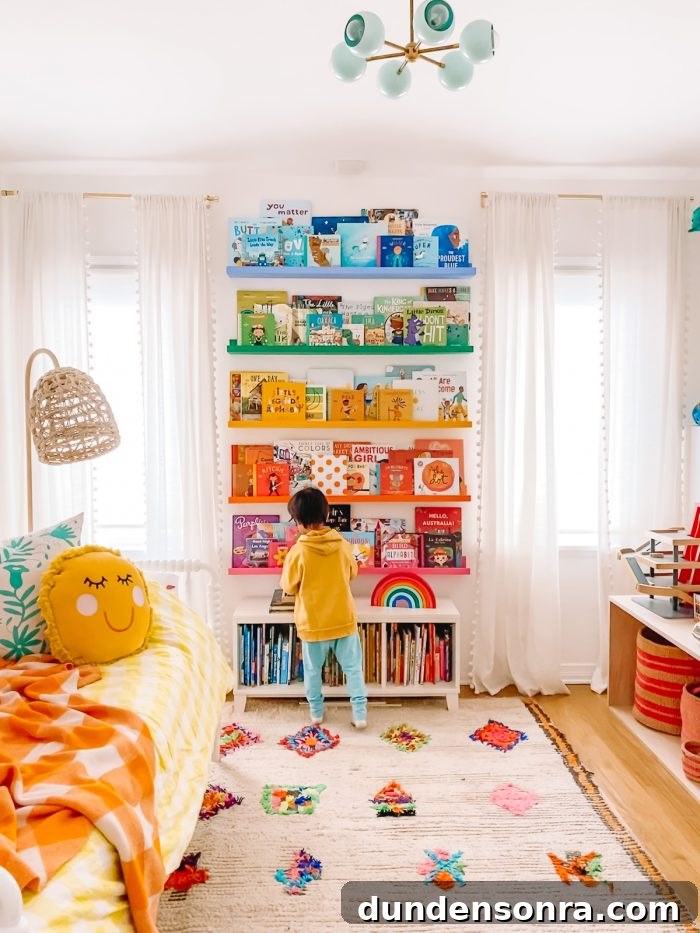 DIY Rainbow Bookshelves: Transform IKEA Shelves with Paint 11 A rainbow-colored shelf with a boy standing in front of it