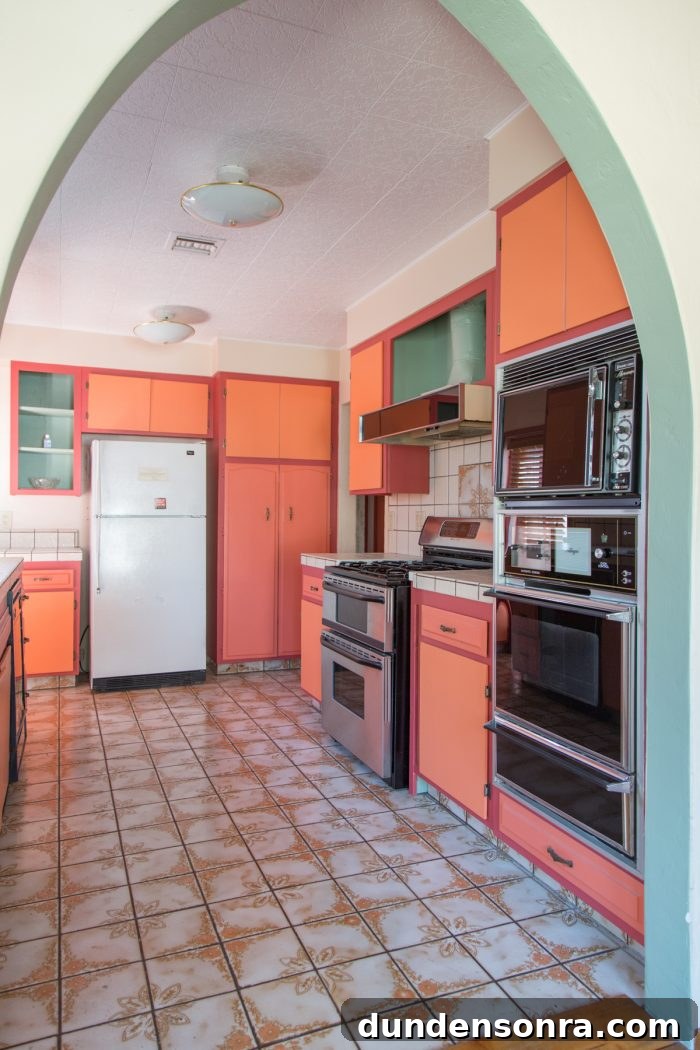 Home Design Wins I’d Use Again: Our Favorite Renovation Choices 8 A kitchen with a fridge, stove, oven, microwave and orange cabinets