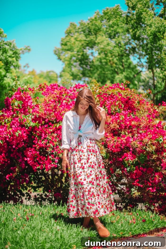 A woman standing in front of flowers