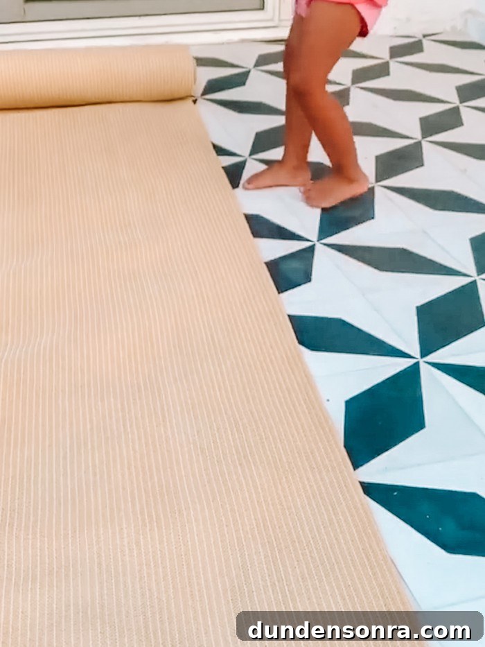 Roll of sun shade fabric on black and white tile