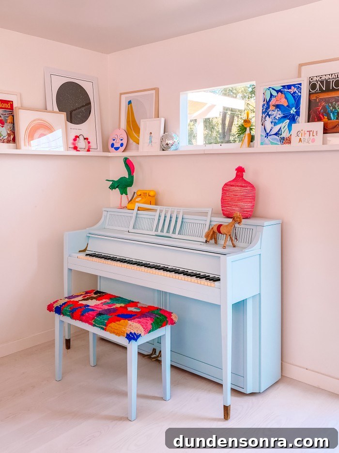 Blue Piano with colorful bench and art ledge behind it