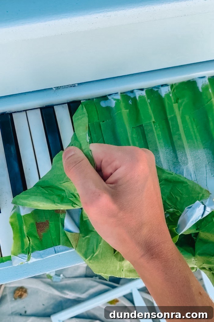 Removing painter's tape from piano keys on a painted piano