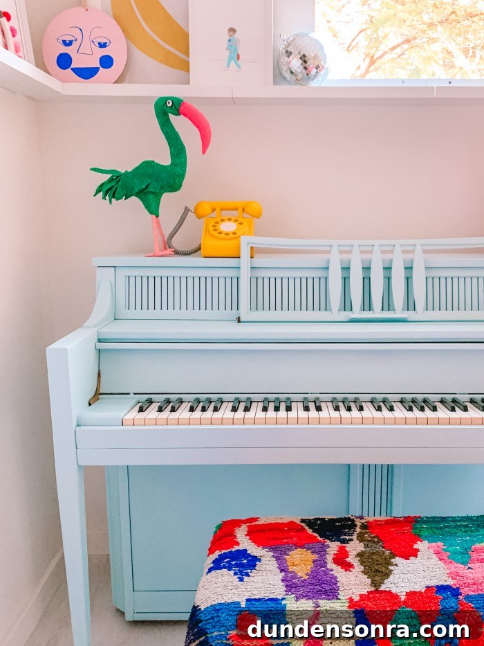 Blue piano in a corner with colorful textile bench and a yellow phone on top