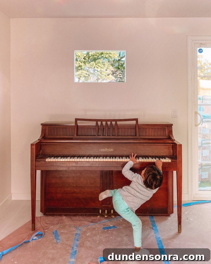 Wood piano with child playing in front of it