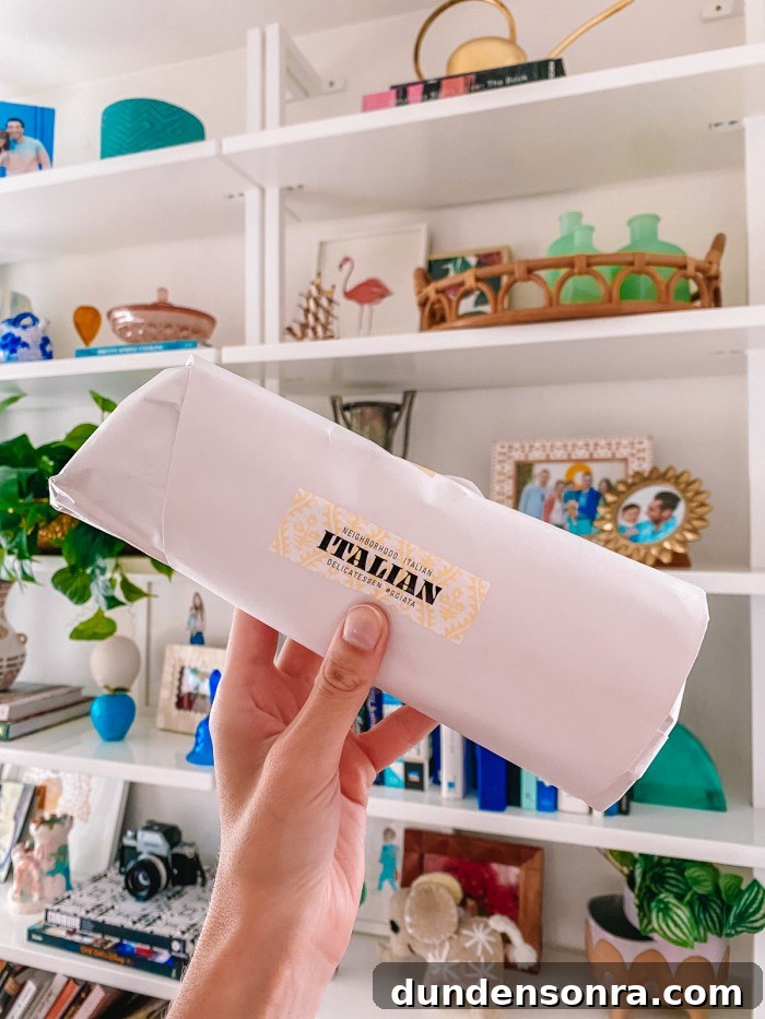 Top Sandwich Spots in Los Angeles: Where Locals Go 15 Wrapped Italian sandwich held in front of bookshelves