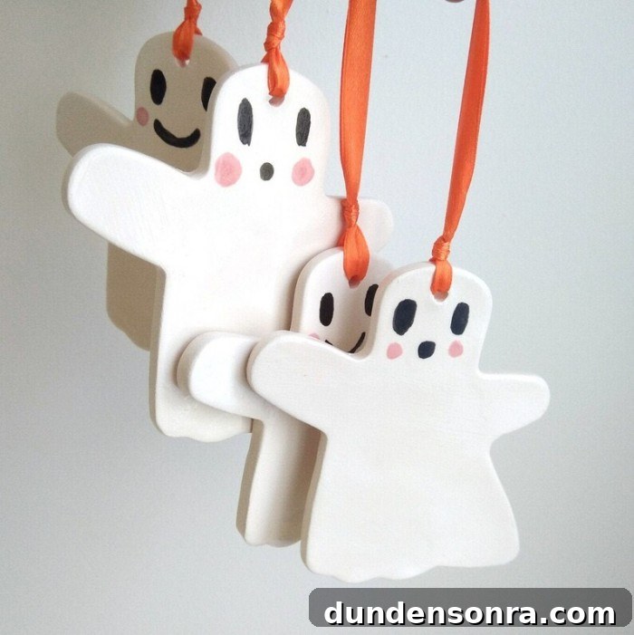 Top Halloween Home Decor Ideas to Transform Your Space 16 ceramic ghost ornaments hanging against a white wall