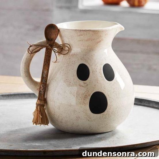 Top Halloween Home Decor Ideas to Transform Your Space 24 Ghost pitcher with wooden spool on a large tray