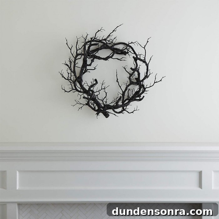 Top Halloween Home Decor Ideas to Transform Your Space 27 Black branch wreath on a white wall over a white mantle