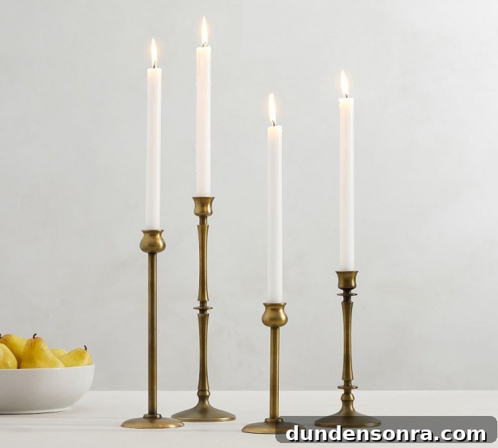 Top Halloween Home Decor Ideas to Transform Your Space 7 four brass candlesticks on a white table