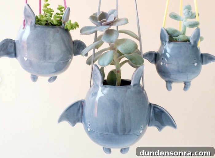 Top Halloween Home Decor Ideas to Transform Your Space 9 hanging bat planters with succulents inside on a white background