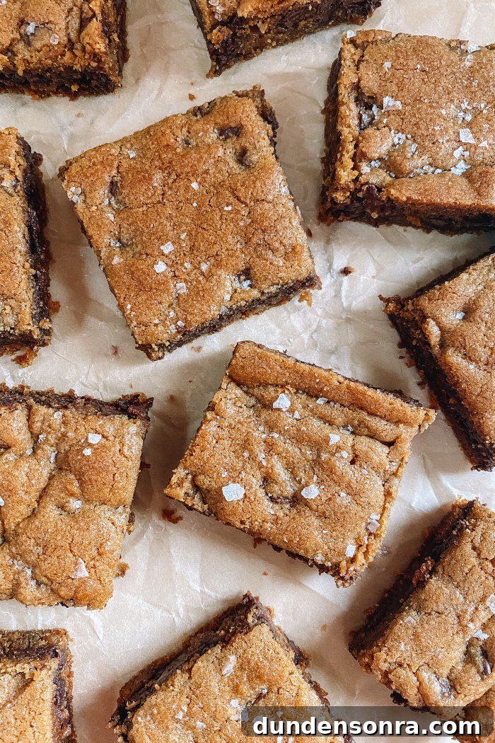 Chewy Chocolate Chip Cookie Bars Recipe for Perfect Snacks 2 chocolate chip cookie bars on parchment paper with flaked salt on top