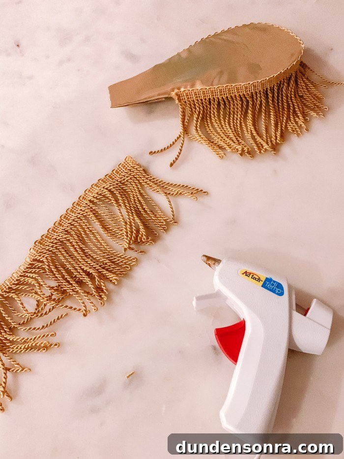 DIY Cinderella Family Costume Ideas for Matching Group Outfits 8 Gold fringe on gold epaulettes with a note glue gun on marble table