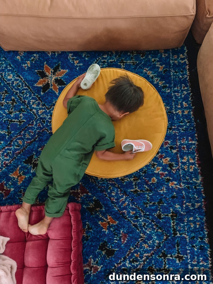 Blue living room rug with child laying on top