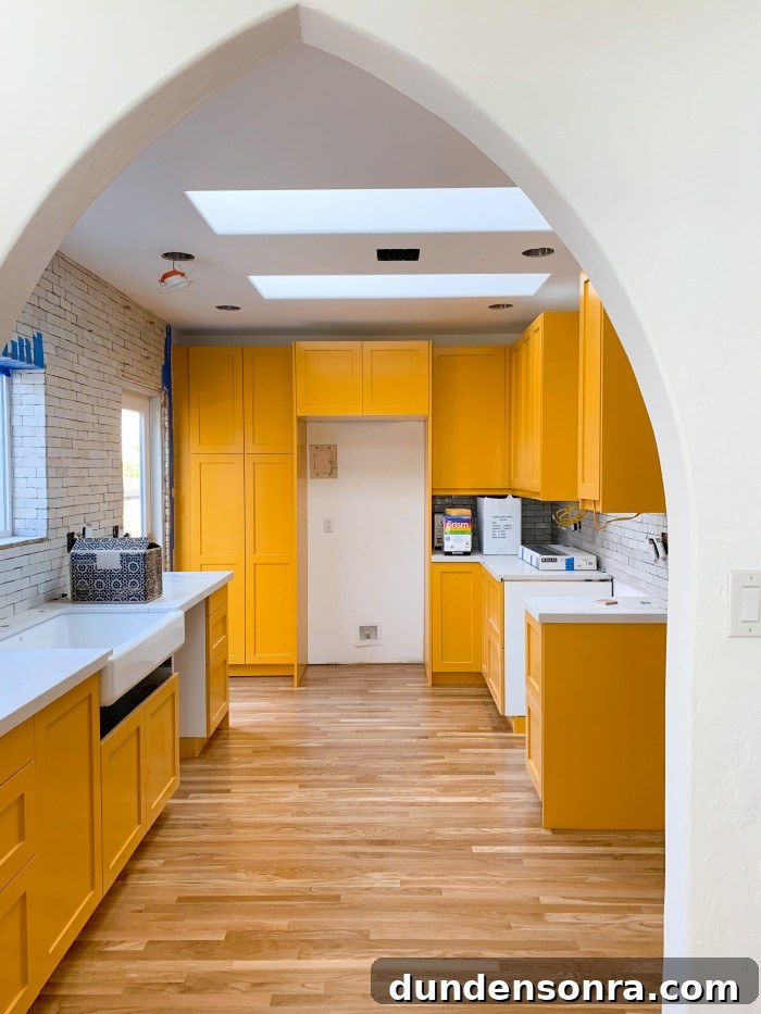 Yellow orange kitchen cabinets with wood floor