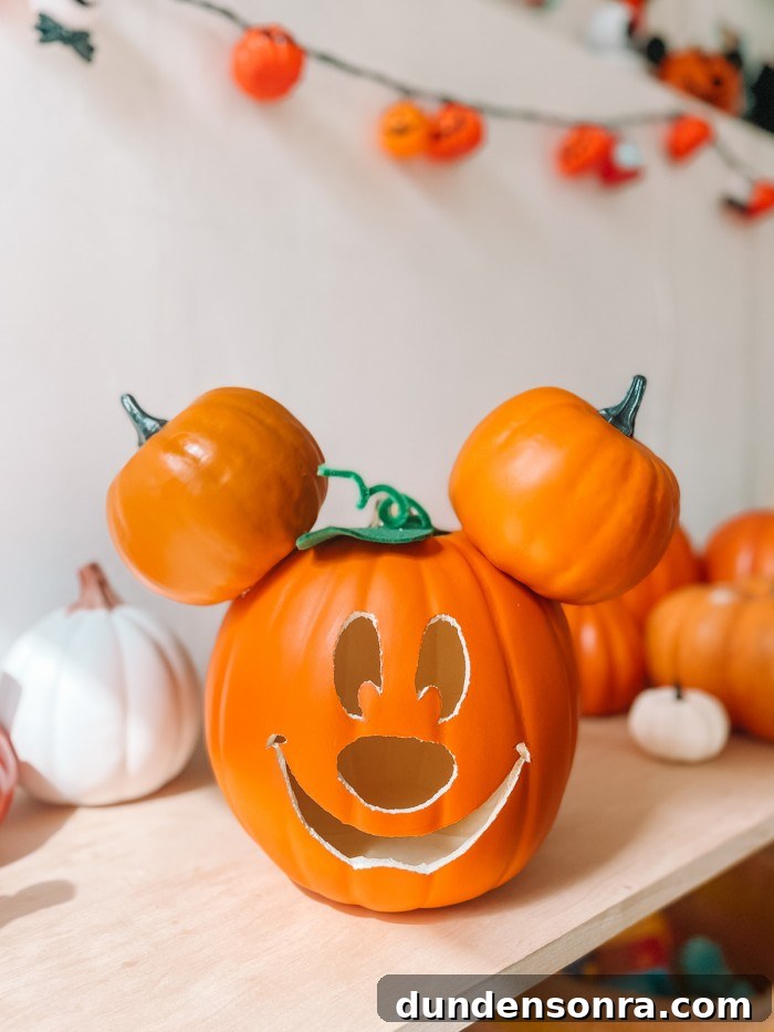 Mickey Mouse Pumpkin Carving and Decorating Guide 12 Mickey Pumpkin on shelf in front of pumpkins and white wall