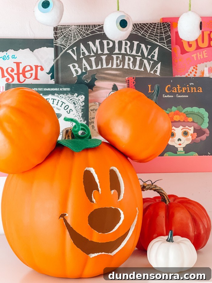 Mickey Mouse Pumpkin Carving and Decorating Guide 3 Mickey pumpkin in front of Halloween books