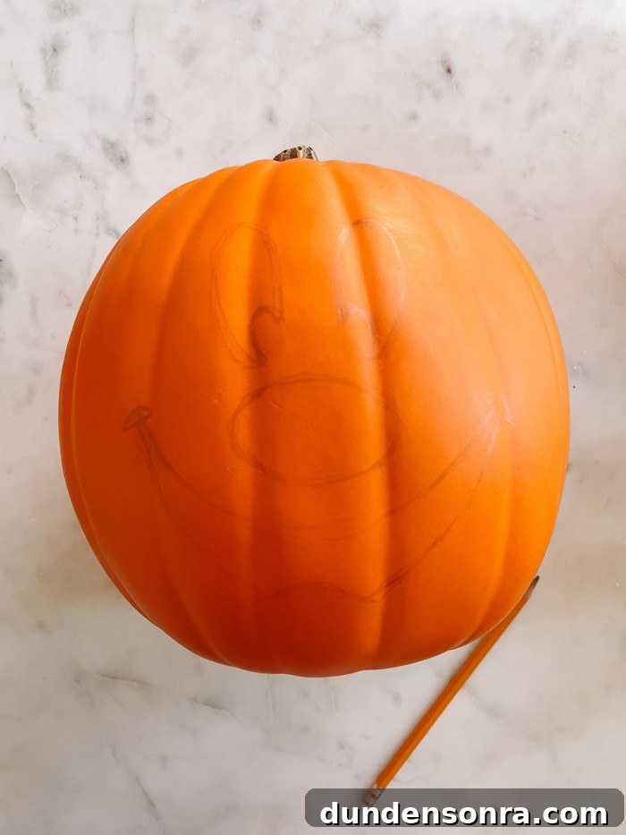 Mickey Mouse Pumpkin Carving and Decorating Guide 5 pumpkin with Mickey face drawn on