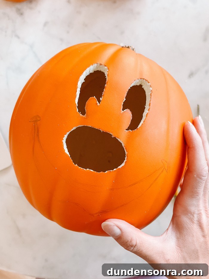 Mickey Mouse Pumpkin Carving and Decorating Guide 6 pumpkin with mickey face partially carved