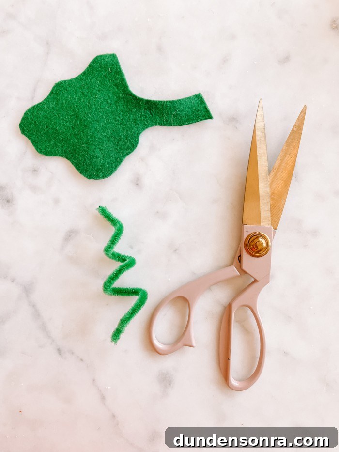 Mickey Mouse Pumpkin Carving and Decorating Guide 8 green felt leaf, green pipe cleaner and scissors on marble table