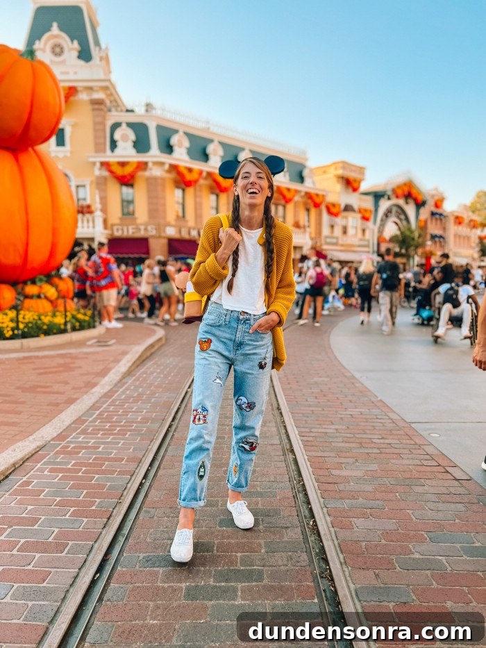 Woman in Disney patch jeans at Disneyland during Halloween