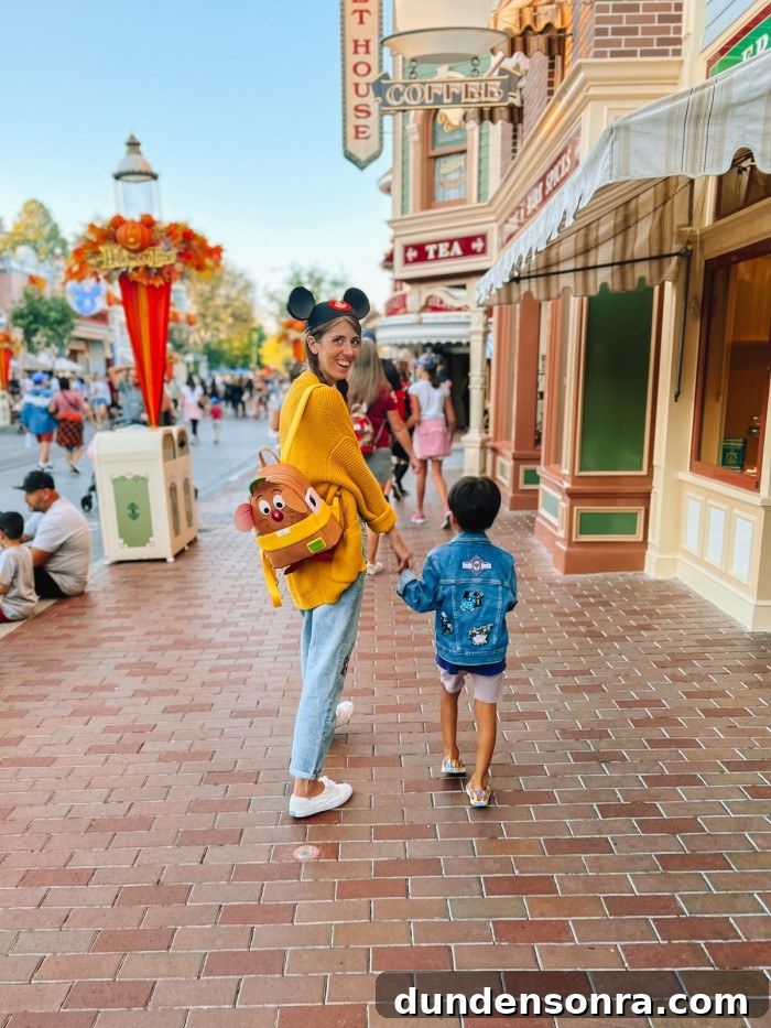 Mom and son walking down Main Street at Disneyland Halloween Time