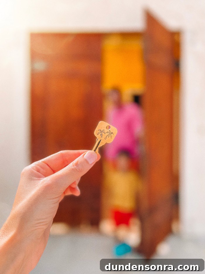 Key held up in front of wooden doors