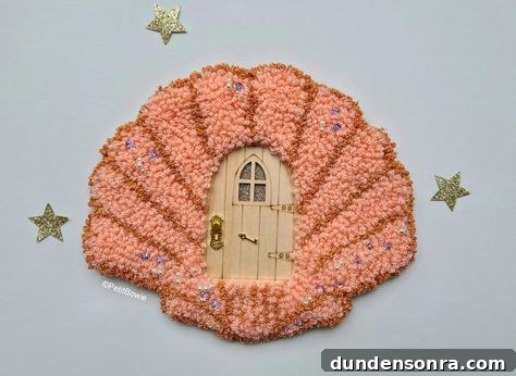 Fairy door with pink sewed shell surrounding it