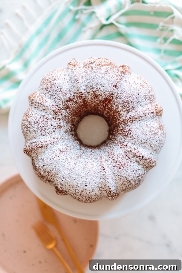 Coffee bundt cake with powdered sugar on cake stand