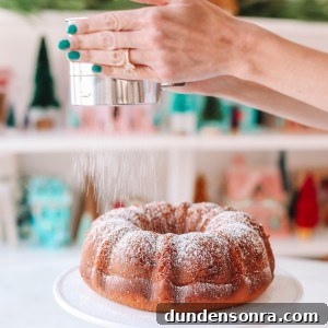 Coffee bundt cake being dusted with powdered sugar