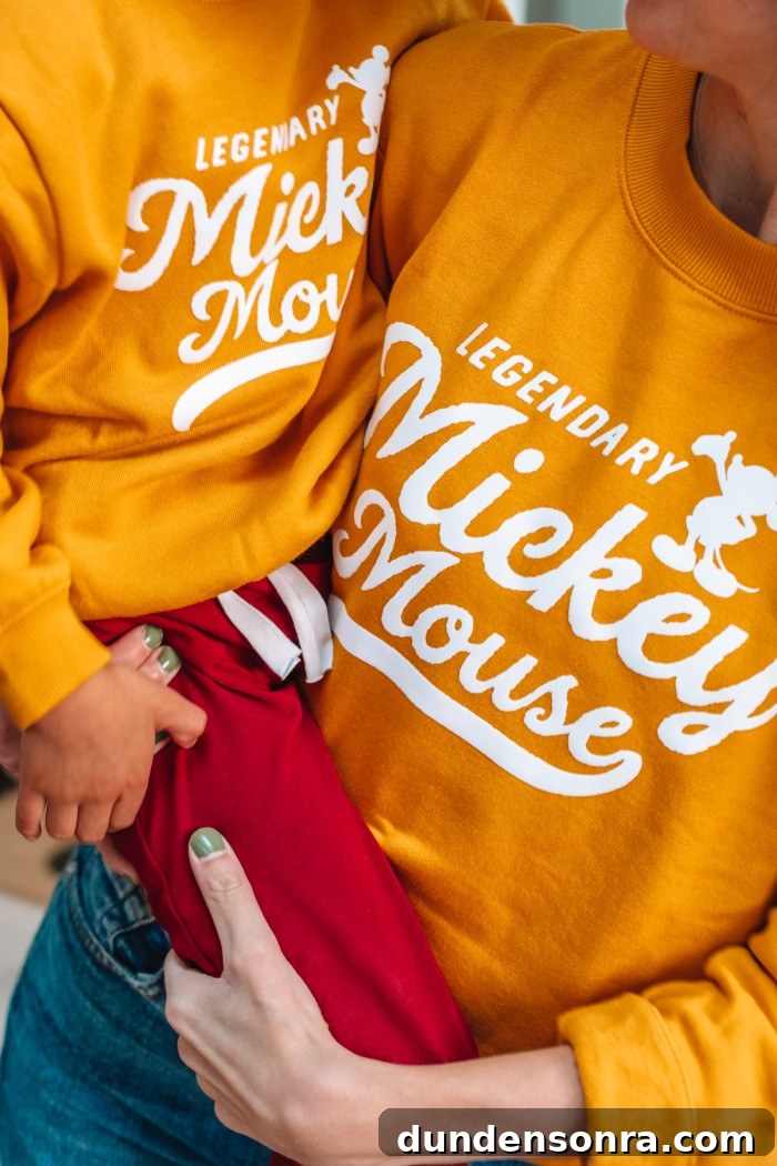 DIY Mommy and Me Disney Shirts: Matching Ideas for Moms & Kids 2 Mom holding child in matching Disney sweatshirts