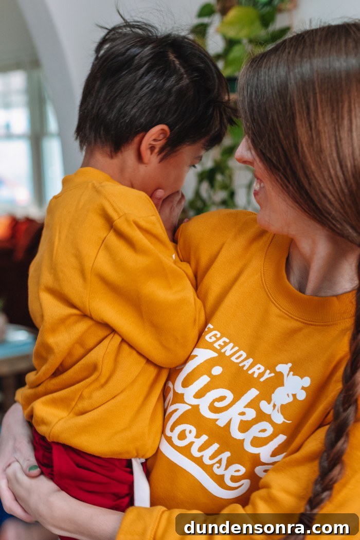 DIY Mommy and Me Disney Shirts: Matching Ideas for Moms & Kids 9 Mom holding child in matching yellow sweatshirts