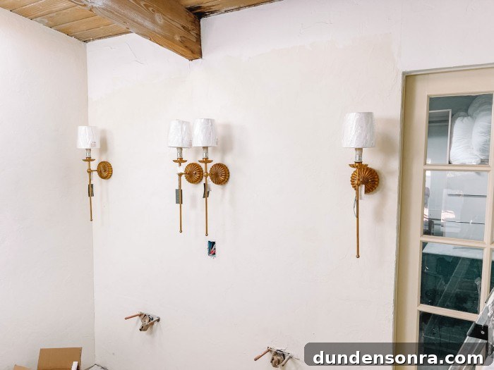 Palm Springs Main Bathroom Remodel Ideas and Plans 6 Brass sconces on wall in bathroom under construction
