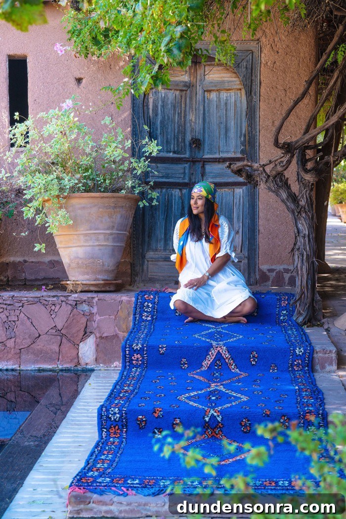 Large blue moroccan rug with woman sitting on it on stairs