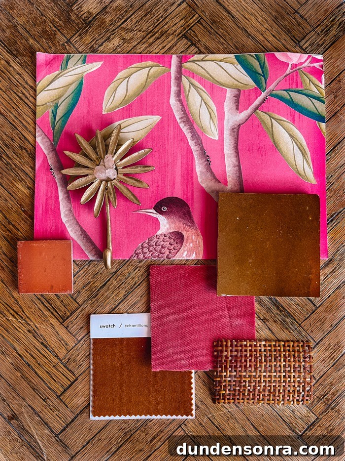 pink wallpaper and tile samples on wood table