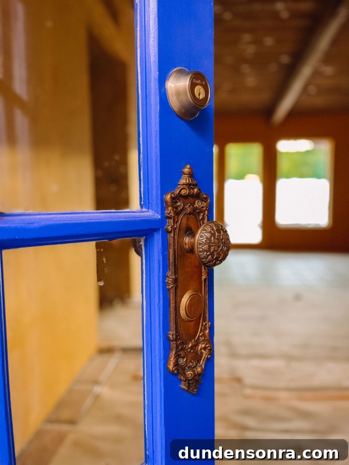 Blue front door with antique brass hardware