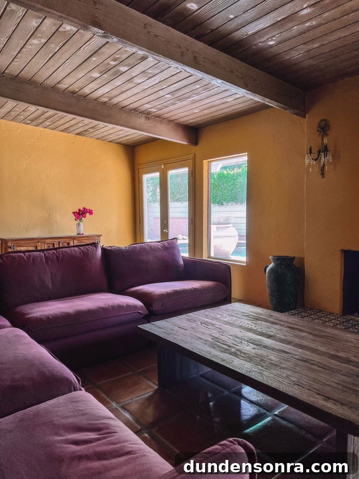purple couch in ochre living room