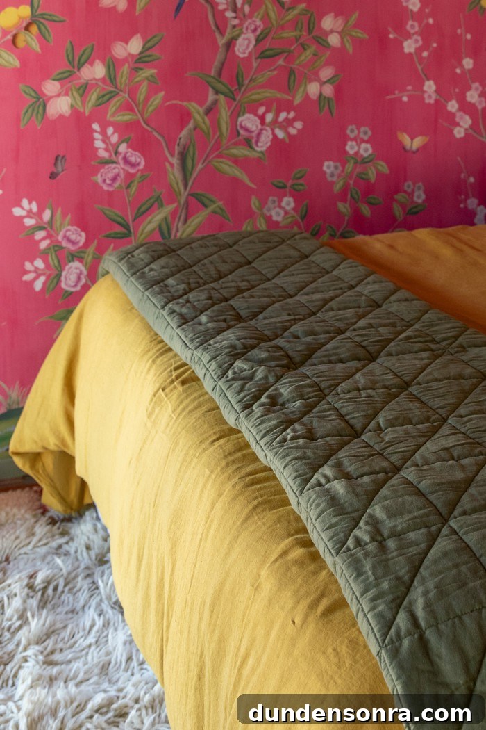 green quilt on end of bed