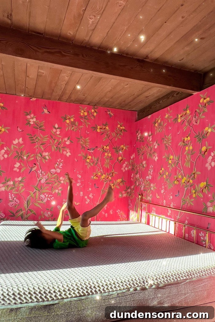 child jumping on mattress in pink bedroom