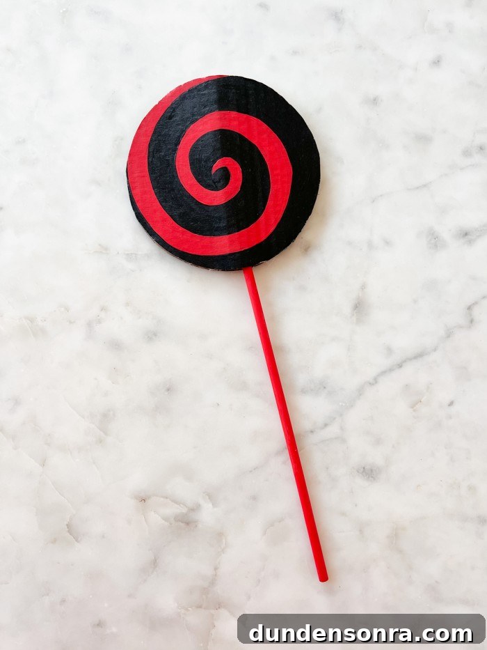 Red and Black Lollipop on marble table